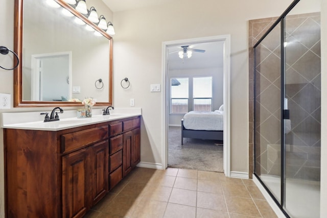 ensuite bathroom featuring a sink, a shower stall, ensuite bath, and tile patterned floors