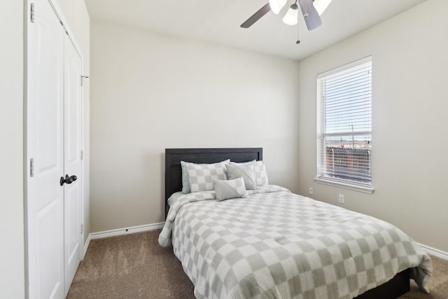 carpeted bedroom featuring a closet, a ceiling fan, and baseboards