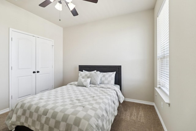 bedroom with a closet, baseboards, ceiling fan, and carpet flooring