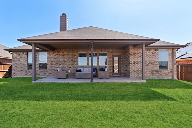 rear view of property with a yard, a patio area, fence, and a chimney