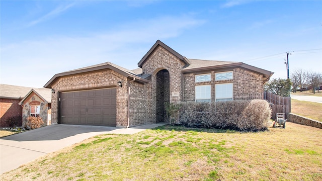 view of front of property featuring brick siding, an attached garage, concrete driveway, and a front lawn