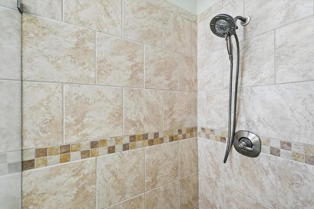 interior details with a tile shower