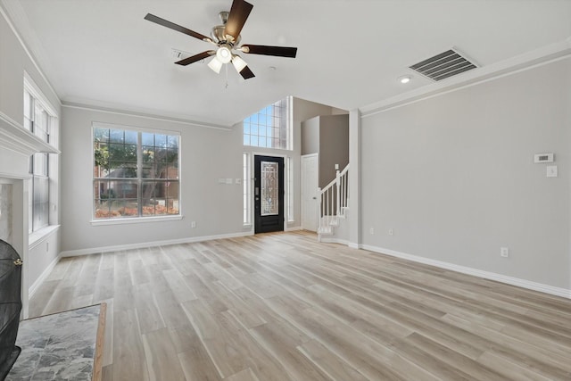 unfurnished living room with stairs, baseboards, visible vents, and light wood finished floors