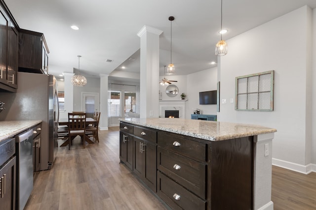 kitchen featuring light wood-style flooring, ceiling fan, a lit fireplace, dark brown cabinetry, and dishwasher