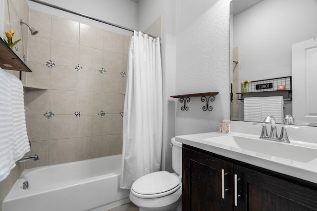 bathroom with vanity, toilet, a textured wall, and shower / tub combo with curtain