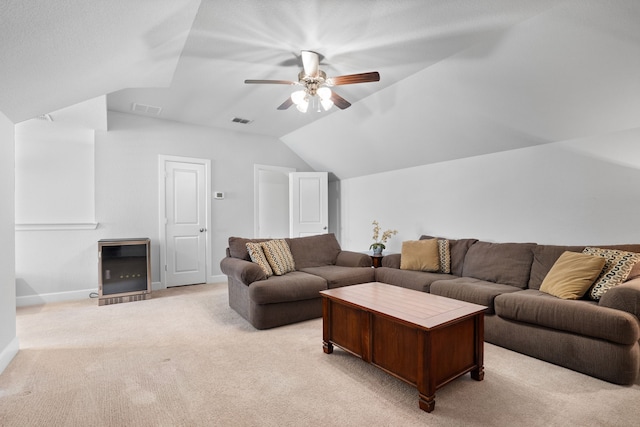 living room with lofted ceiling, a ceiling fan, visible vents, and light carpet