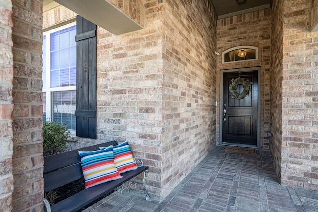 doorway to property with brick siding