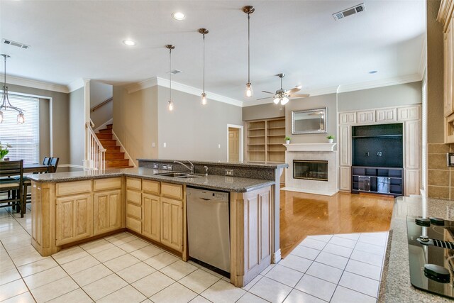 kitchen featuring light brown cabinetry, visible vents, a sink, and stainless steel dishwasher