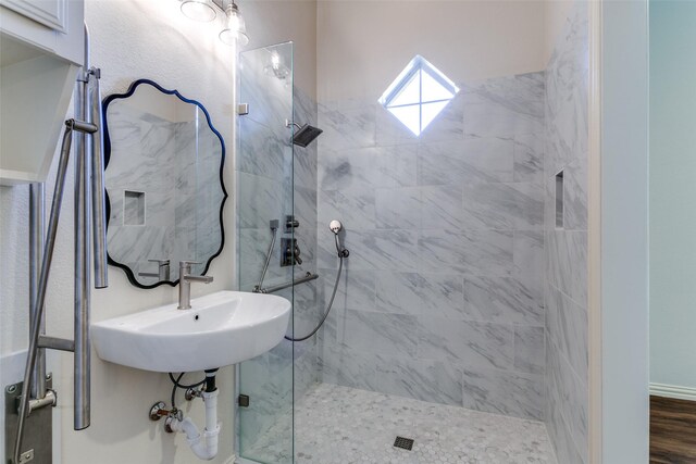 bathroom featuring a sink and tiled shower