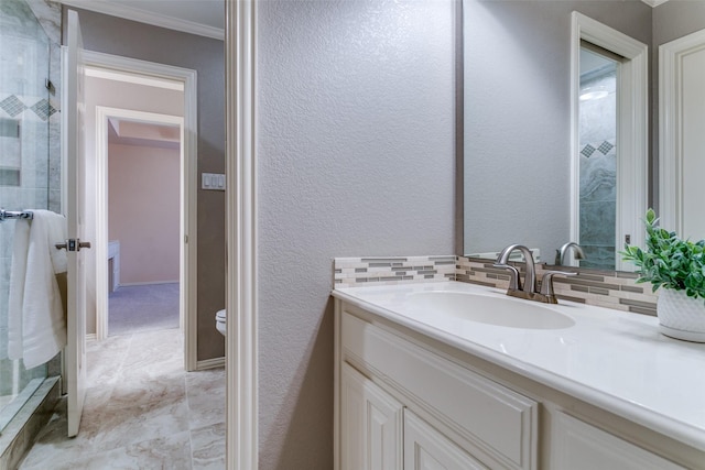 bathroom with ornamental molding, tasteful backsplash, a tile shower, vanity, and a textured wall