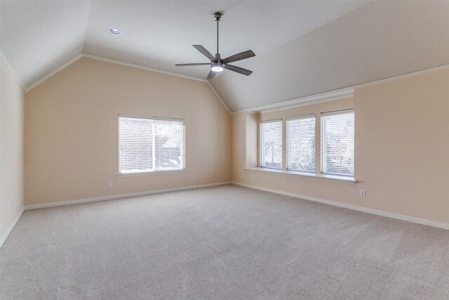 empty room featuring baseboards, carpet, a ceiling fan, and vaulted ceiling