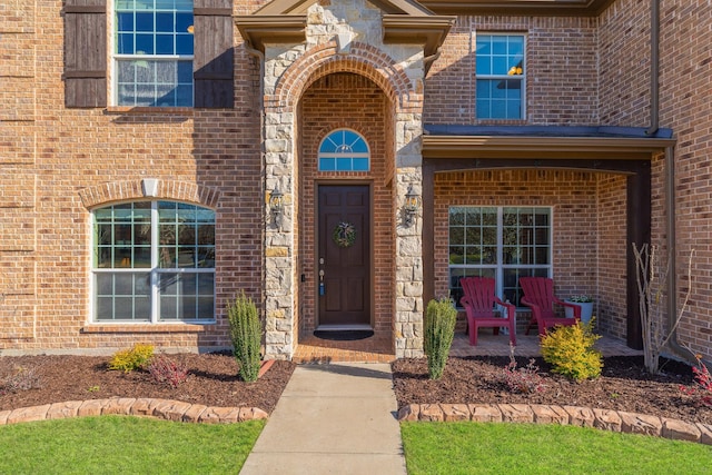 doorway to property featuring brick siding