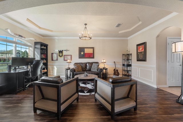 living area featuring arched walkways, visible vents, a decorative wall, and a raised ceiling