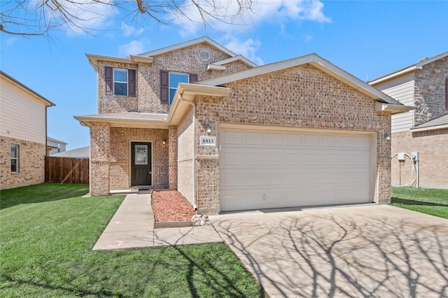 traditional-style home with brick siding, an attached garage, a front lawn, and fence