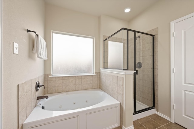 bathroom with recessed lighting, a tub with jets, a stall shower, and tile patterned flooring