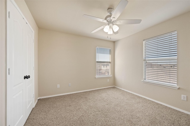 unfurnished bedroom featuring a ceiling fan, carpet flooring, baseboards, and a closet