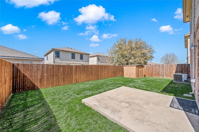 view of yard featuring a patio area, central AC unit, and a fenced backyard