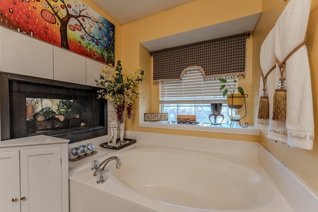 full bathroom with a garden tub and a multi sided fireplace