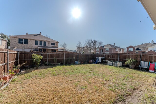 view of yard with a fenced backyard and a residential view