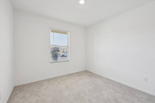 unfurnished room with baseboards and carpet floors