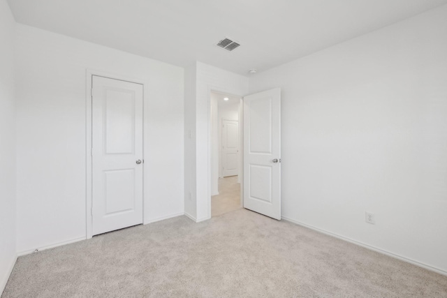 unfurnished bedroom featuring visible vents, baseboards, and carpet