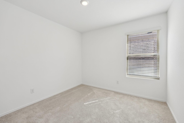 spare room with carpet flooring and baseboards