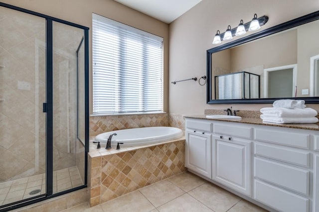 full bath with tile patterned flooring, a shower stall, a bath, and vanity