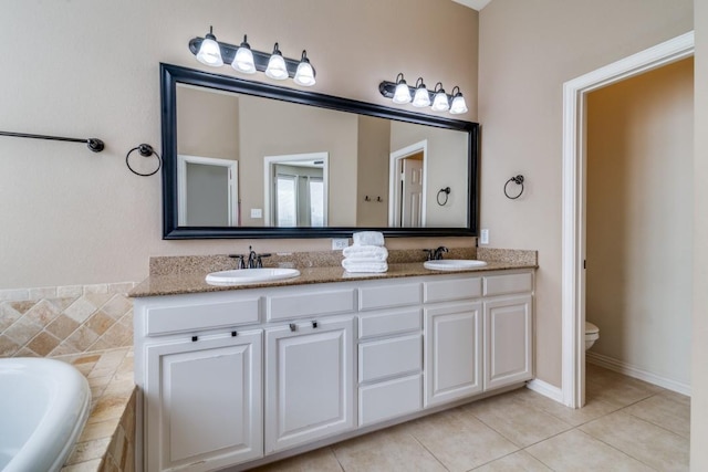 full bath with tile patterned floors, toilet, double vanity, and a sink