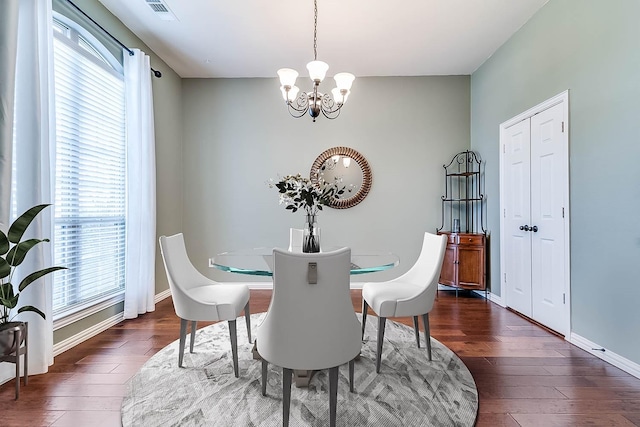 dining area featuring visible vents, plenty of natural light, and dark wood-style flooring