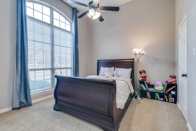 bedroom with ceiling fan, baseboards, and carpet