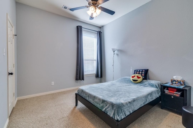 carpeted bedroom with baseboards, visible vents, and ceiling fan