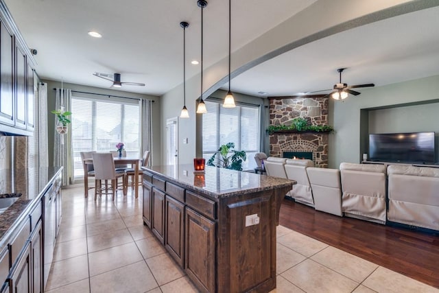 kitchen with light tile patterned flooring, a healthy amount of sunlight, and ceiling fan