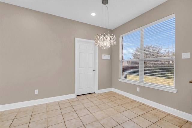 empty room featuring a chandelier, recessed lighting, baseboards, and light tile patterned flooring