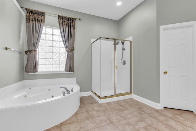 full bathroom featuring tile patterned floors, baseboards, a stall shower, and a whirlpool tub