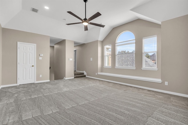 unfurnished living room featuring visible vents, a ceiling fan, carpet flooring, baseboards, and vaulted ceiling