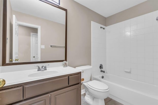 bathroom featuring tile patterned floors, shower / washtub combination, toilet, and vanity