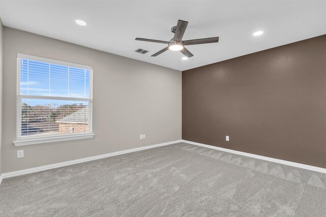 carpeted spare room featuring recessed lighting, baseboards, visible vents, and ceiling fan