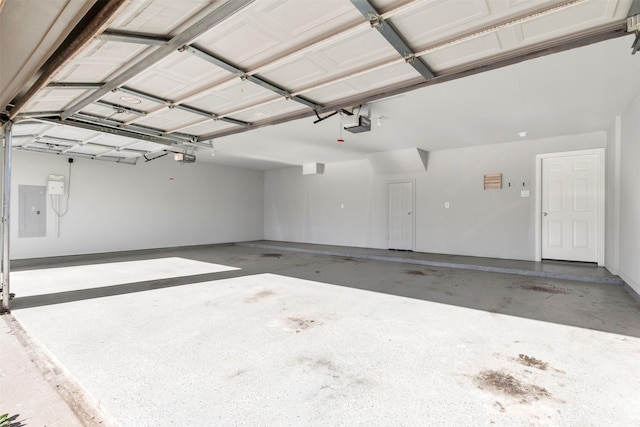 garage featuring electric panel and a garage door opener