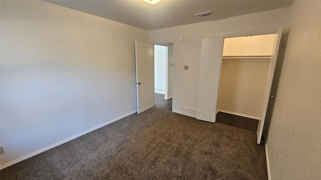 unfurnished bedroom with a closet, carpet flooring, baseboards, and visible vents