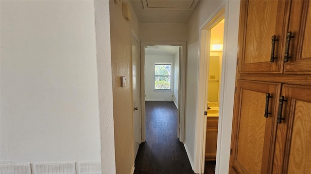 hall featuring dark wood-style floors and baseboards