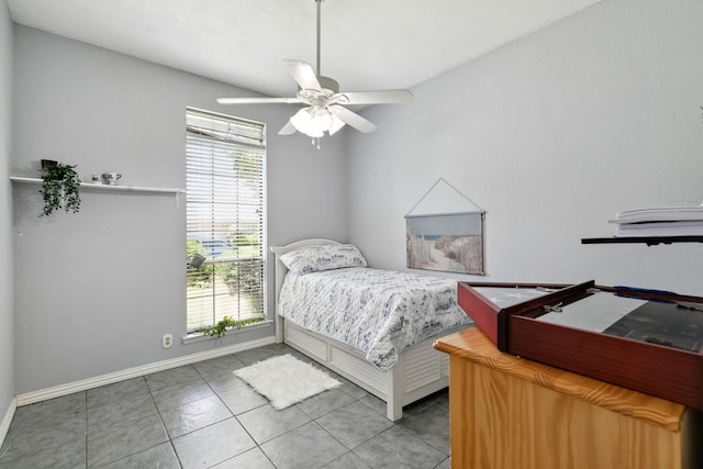 bedroom featuring tile patterned floors, baseboards, and ceiling fan