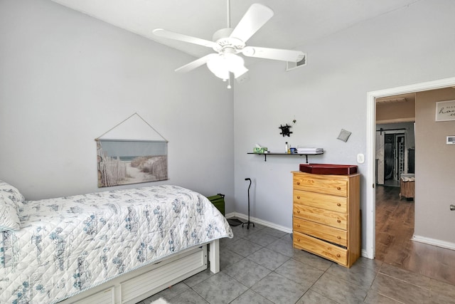 tiled bedroom featuring visible vents, ceiling fan, and baseboards