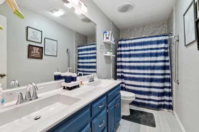 bathroom with double vanity, toilet, a shower with curtain, and a sink