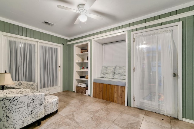 sitting room with a ceiling fan and visible vents