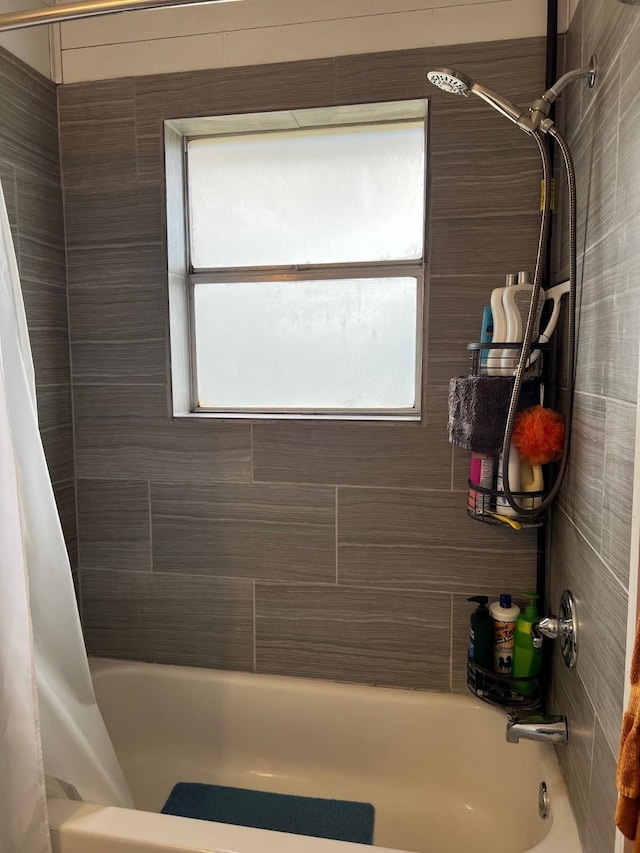 bathroom with shower / bath combo with shower curtain