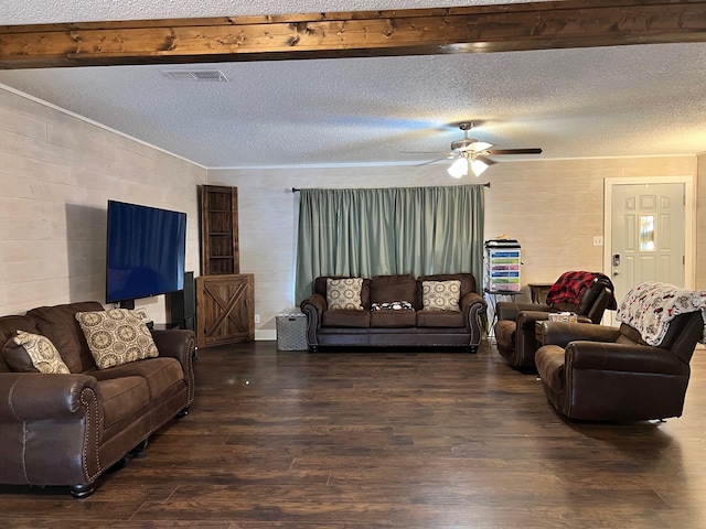 living area with visible vents, dark wood-type flooring, a ceiling fan, and a textured ceiling