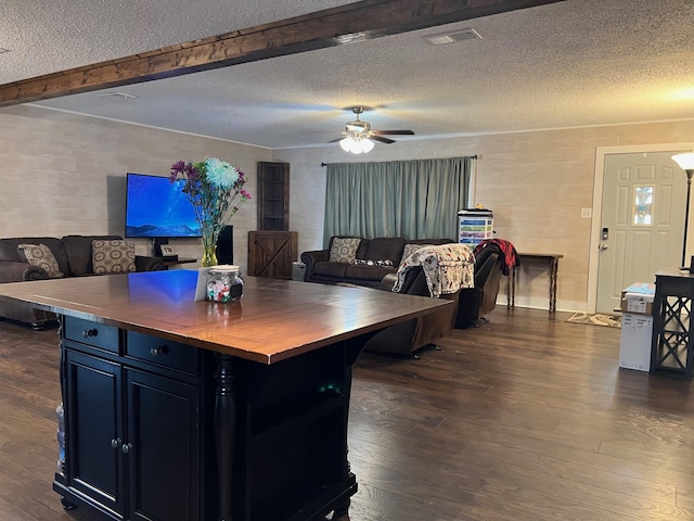 kitchen with visible vents, open floor plan, dark wood-style flooring, and wood counters