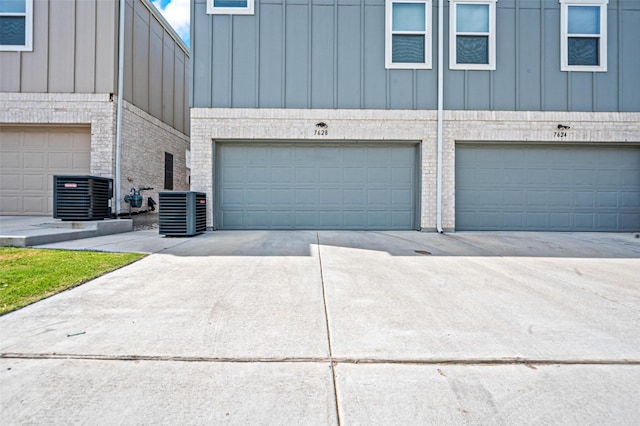 garage with cooling unit and driveway