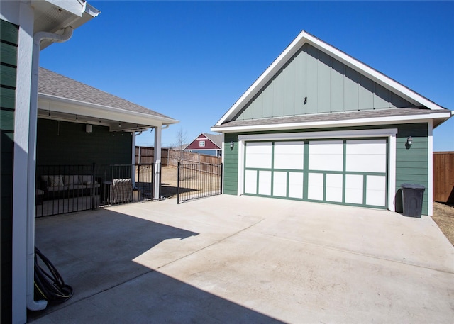 detached garage featuring fence