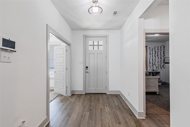 entrance foyer with baseboards and wood finished floors